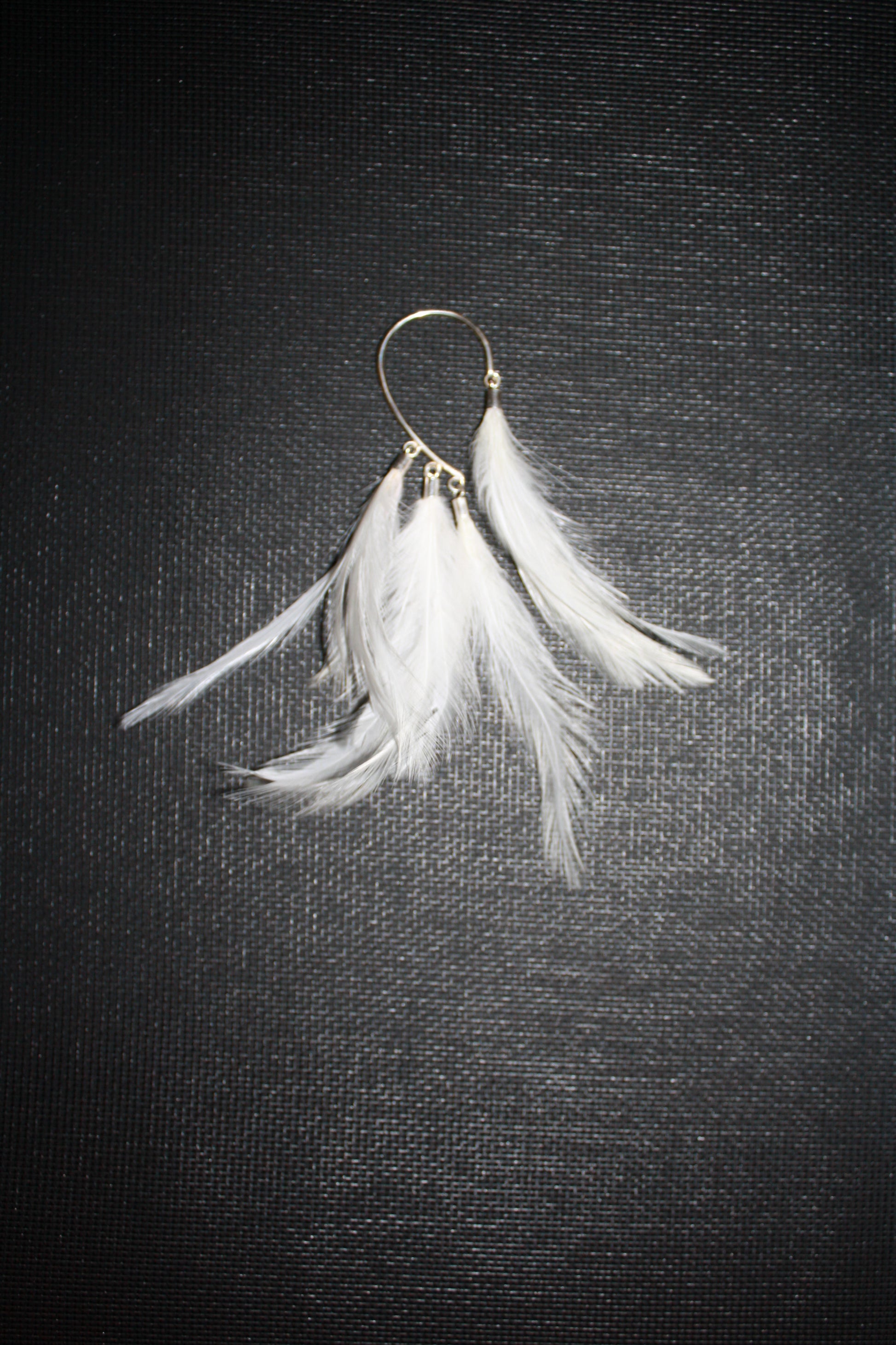 white feather ear hook in sterling silver